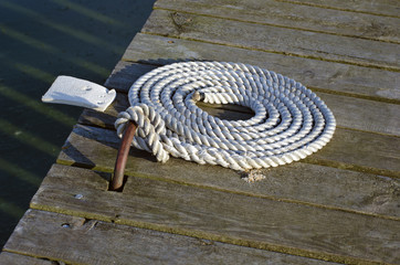nautical mooring rope on wooden pier