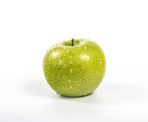 whole green apple with water drops