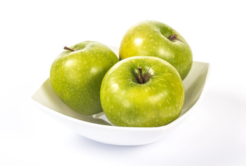 three green apples in a white bowl
