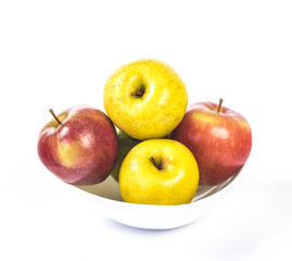 multicolored apples in a white bowl
