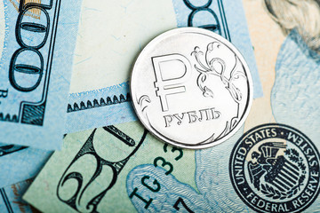 russian rouble coins on banknotes of us dollars