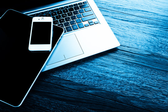 Keyboard With Phone And Tablet Pc On Wooden Desk