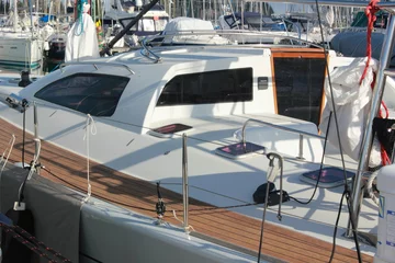 Fotobehang modern white sleek sail yacht  boat in marina © William Richardson