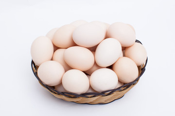 Eggs in basket isolated on white background