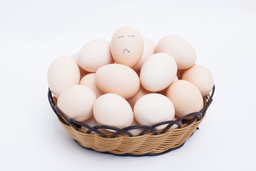 Eggs in basket isolated on white background