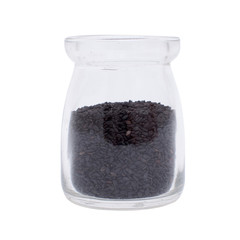 Bottle of black seeds isolated on white background