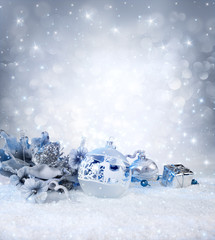 silver balls and decoration on snow - sparkling background