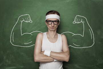 Funny sport nerd with fake muscle drawn on the chalkboard - obrazy, fototapety, plakaty