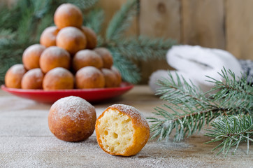 Obraz na płótnie Canvas Christmas donuts with powdered sugar with fir branch