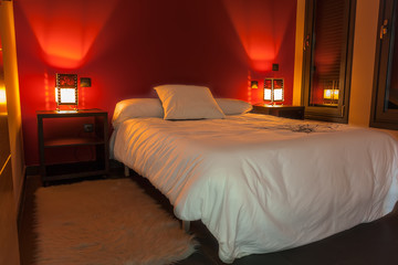 Bedroom decorated in white and red, relaxing light