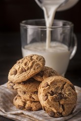 chocolate cookie with milk on wooden table