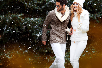 Happy couple near a Christmas tree. Christmas Eve.