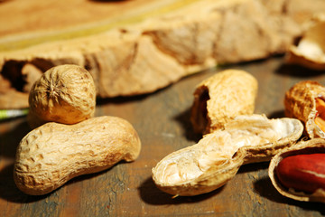 Peanuts in bowl on rustic wooden background