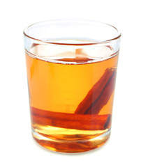 Apple cider with cinnamon sticks, isolated on white