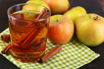 Apple cider with cinnamon sticks and fresh apples