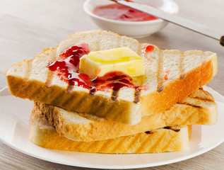 Slices of toast bread with butter and jam