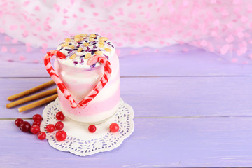 Cranberry milk dessert in glass jar,