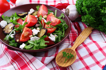 Eggplant salad with tomatoes, arugula and feta cheese,