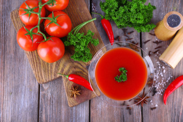 Tomato juice in goblet and fresh vegetables