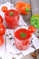 Tomato juice in glasses and fresh vegetables