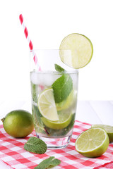 Lemonade in glass on napkin on bright background
