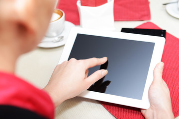 Woman with tablet computer in cafe shop