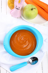 Fresh baby food in bowl with spoon