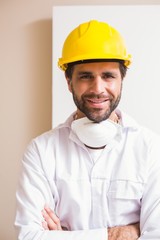 Carpenter wearing protective mask smiling at camera