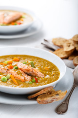 Healthy puree soup with salmon and white bread snacks