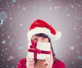 Portrait of a festive young woman holding a gift