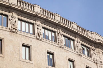 Fototapeta na wymiar Antique facade with sculptures and blue sky
