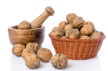 Walnuts in a basket and a wooden mortar