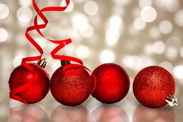 Composite image of four red christmas ball decorations