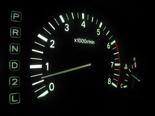 The tachometer on the instrument panel in the car