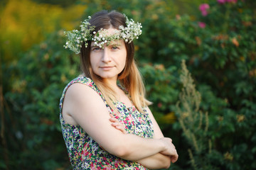 Pretty young woman with wreath on head