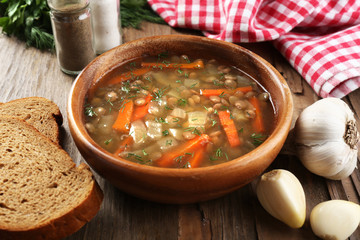 Delicious lentil soup on table close-up