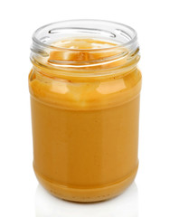 Creamy peanut butter in jar, isolated on white