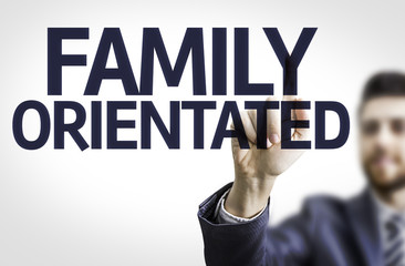 Business man pointing the text: Family Orientated