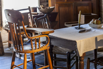 Table and baby chair in very old kitchen
