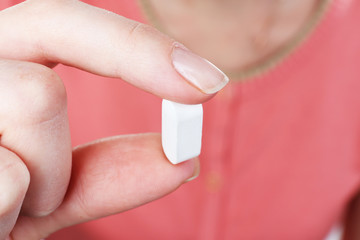 Pill in hand, close-up