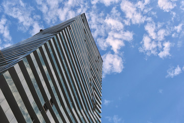 Fototapeta na wymiar glass building skyscraper, sunny day, cloudy sky