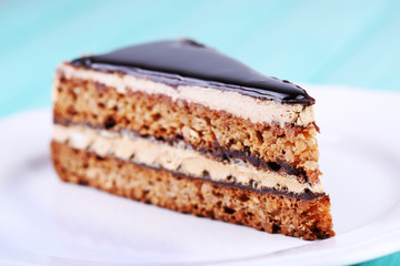 Delicious chocolate cake on plate on table close-up