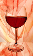 Red wine glass of wine on bright background