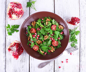 Fresh salad with greens, garnet and spices