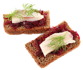 Canape herring with beets on rye toast, isolated on white