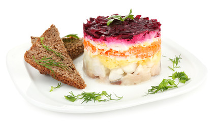 Russian herring salad on plate isolated on white