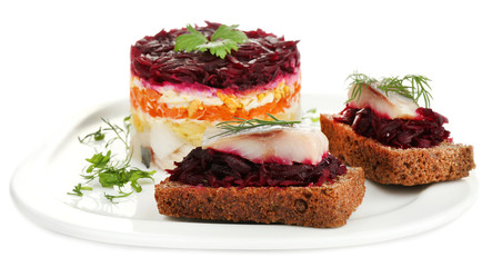 Russian herring salad  and sandwiches on plate isolated on