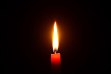 Red candle burning on a black background