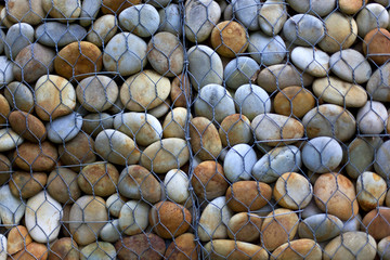 Pebbles stored behind a grid