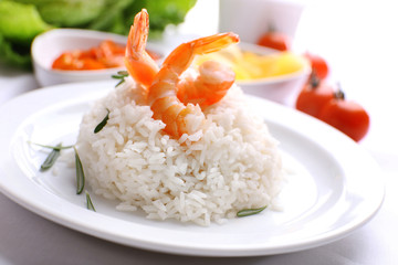 Boiled rice with shrimps served on table, close-up